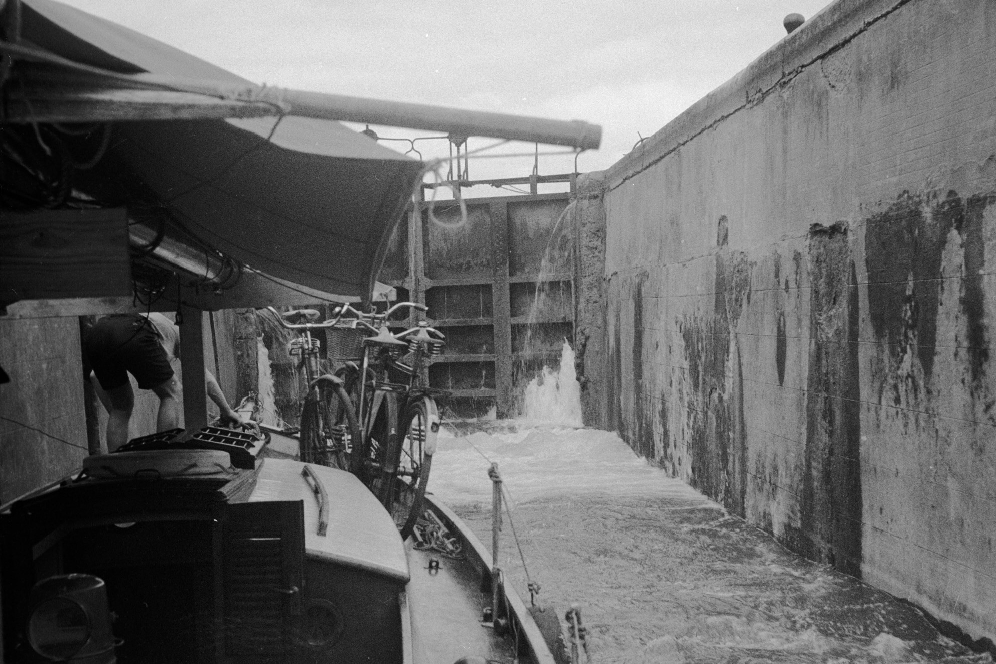 Sailing yacht Daphne inside a Canal de Bourgogne lock in 1948 with her mast carried horizontally on deck