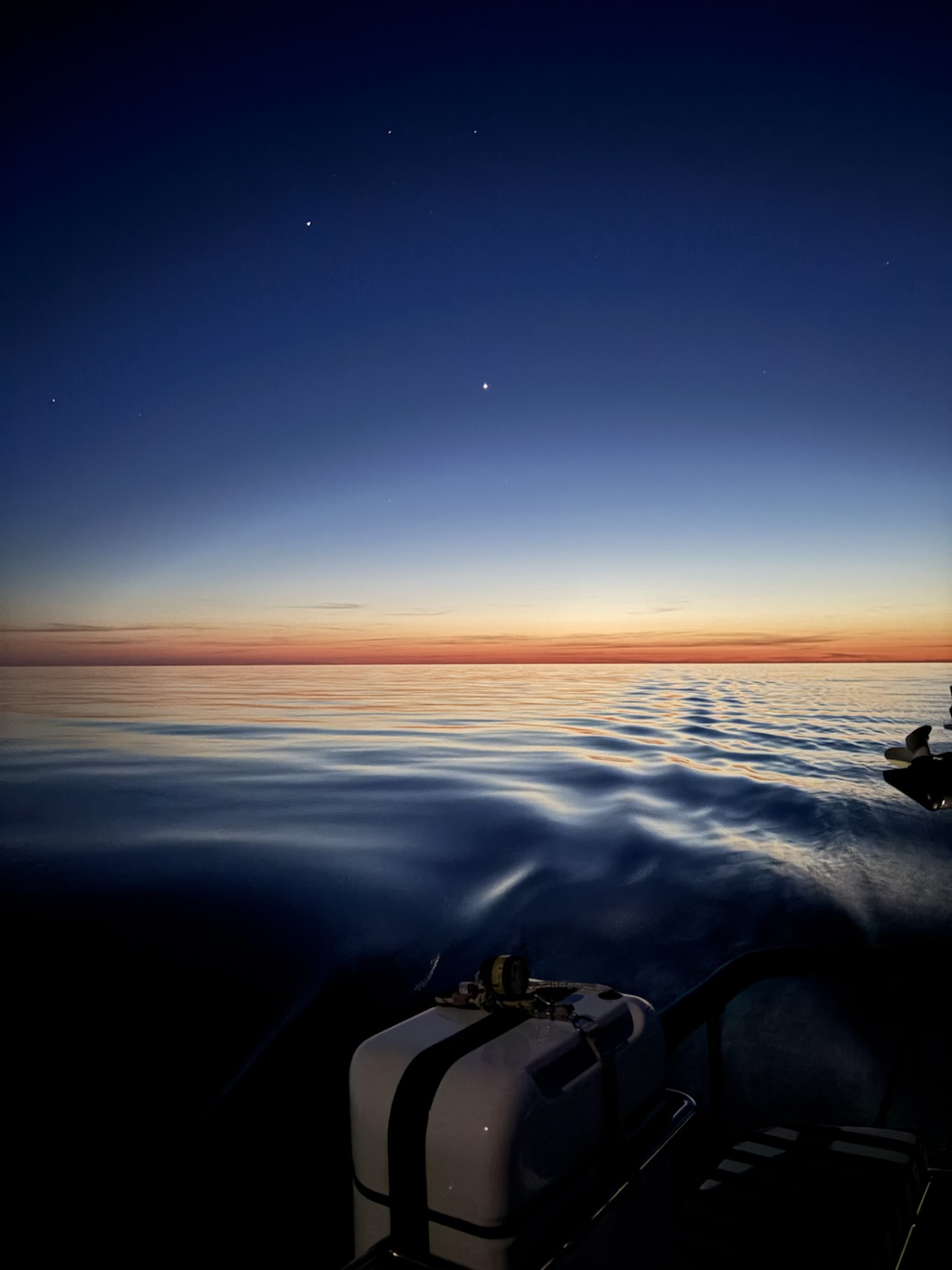 Calm Mediterranean water and the last light of evening during the passage