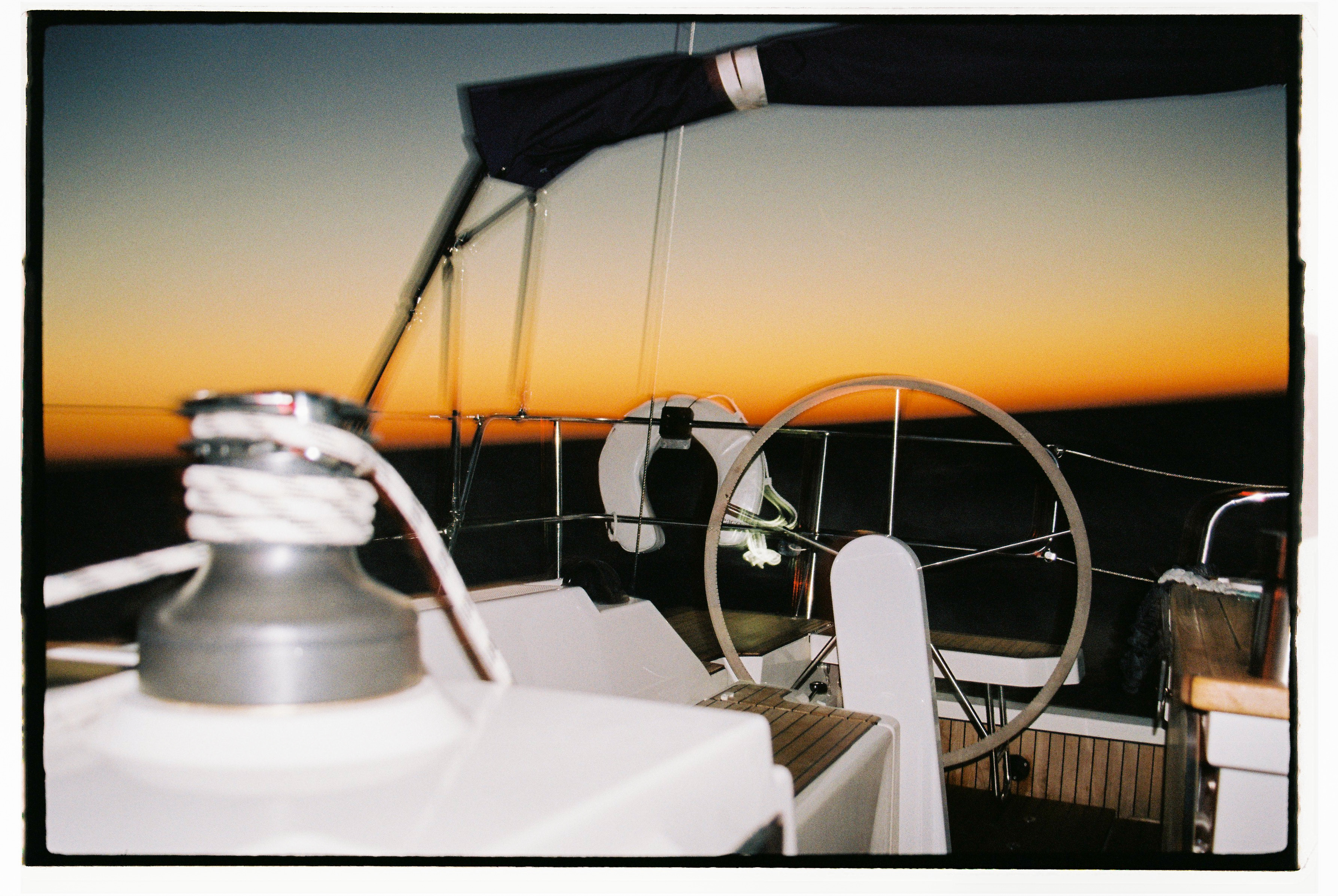 A sailing yacht cockpit at sea after sunset